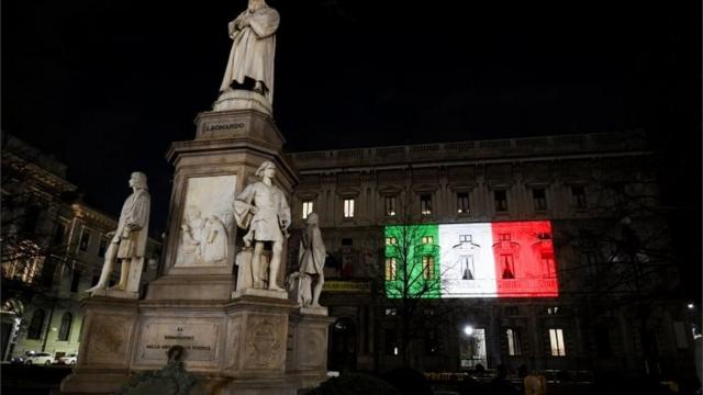 The Palazzo Marino building is seen iluminated with the colours of the Italian flag as the spread of coronavirus disease