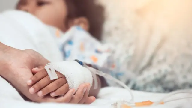 mano de una niña sometiéndose a quimioterapia