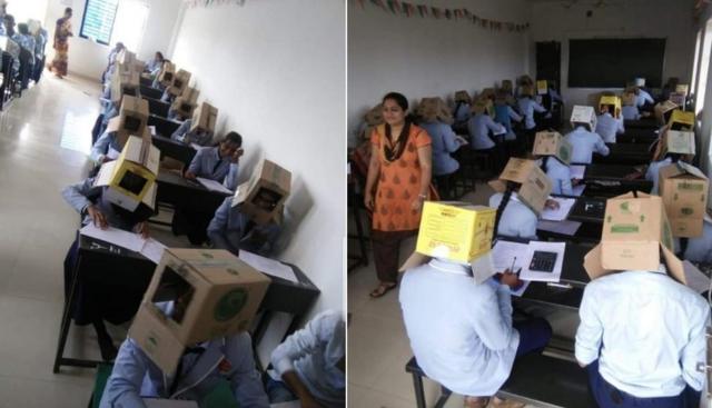 Fotos mostram estudantes indianos fazendo prova com caixa de papelão na cabeça
