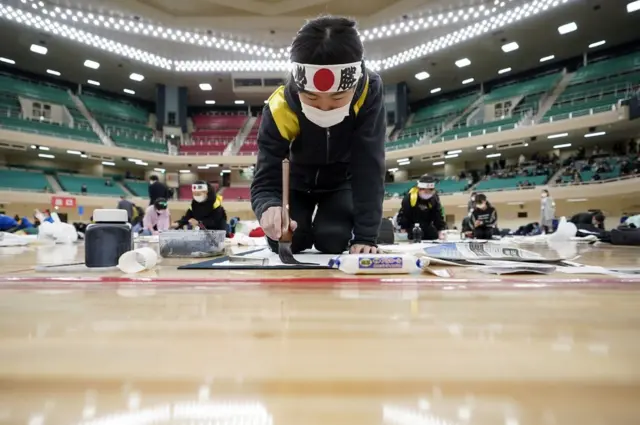 A student participates during the new year's first calligraphy contest