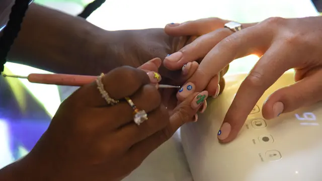 Kadimah Aaliyah works on Kwasi Ritchie-Row's nails