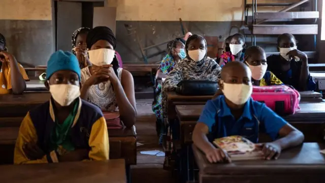 Students from the Madamou Goundo Simaga School wear face masks as a preventive measure against the spread of COVID-19, as they start the new school year in Bamako on January 25, 2021.