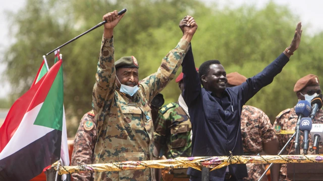 Lt-Gen Abdel Fattah Abdelrahman Burhan (L) next to newly inaugurated Darfur governor Minni Minawi in el-Fasher, Sudan - Wednesday 8 August 2021