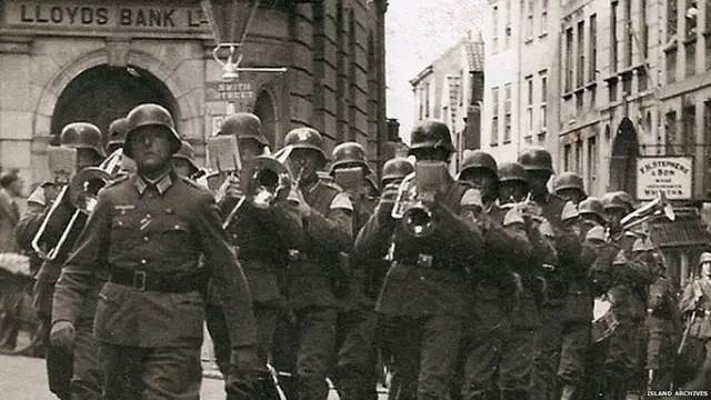 A German band marches through Guernsey's St Peter Port High Street