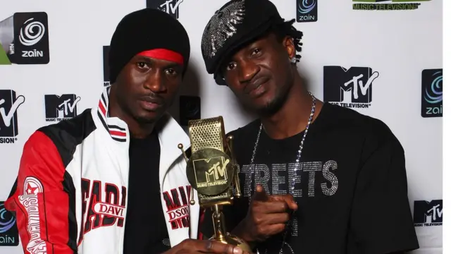PSquare holding an award.