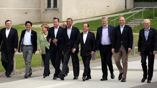 Barack Obama, Francois Hollande, Angela Merkel y otros líderes políticos caminan en una cumbre del G8.