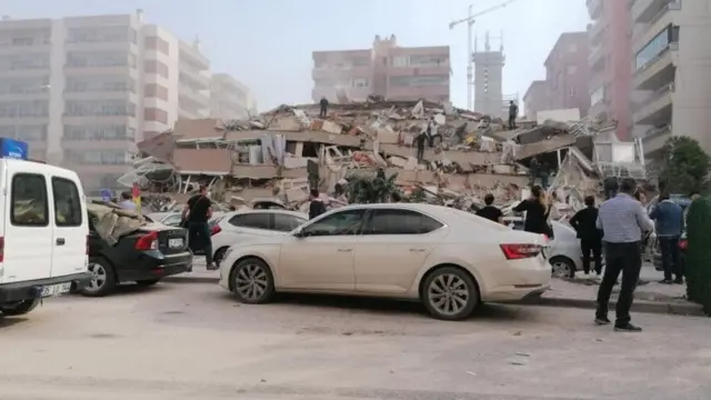 People gather as rescuers search for survivors in Izmir, Turkey. Photo: 30 October 2020