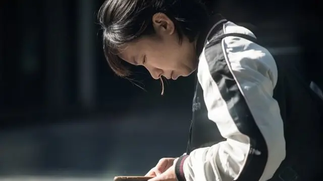 Woman distracted by smartphone