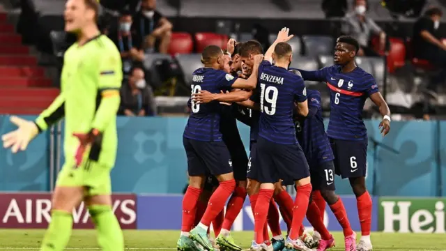France players celebrate behind Germany goalkeeper Manuel Neuer