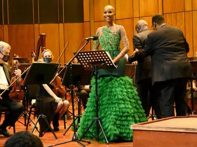 Shudu Musida stands a lectern next to players of the Philharmonic Orchestra in Johannesburg, South Africa - Saturday 12 February 2022