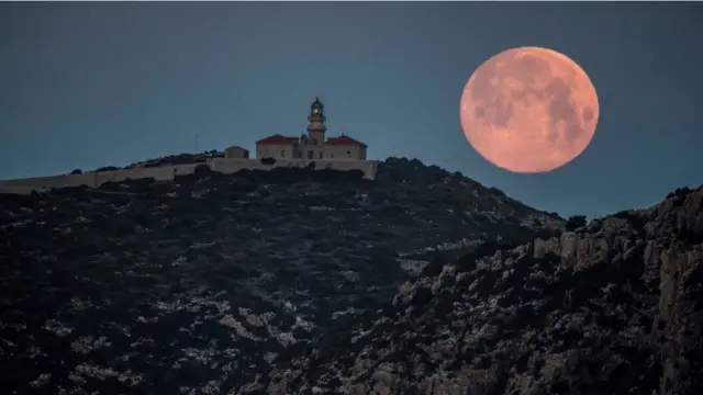 View of the Blue Moon from the village of Sant Elm, in Majorca Island, eastern Spain, early 31 March 2018.