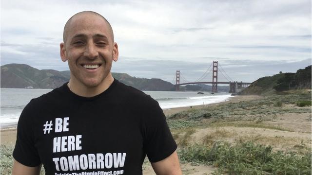 Kevin Hines posing with the Golden Gate Bridge in the background