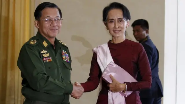 Min Aung Hlaing shakes hands with National League for Democracy (NLD) party leader Aung San Suu Kyi in December 2015