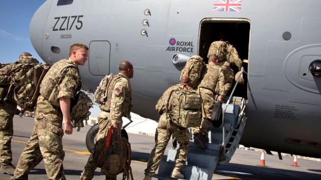 British troops board a RAF C-17 as they leave Afghanistan to go home at Kandahar airfield in 2014