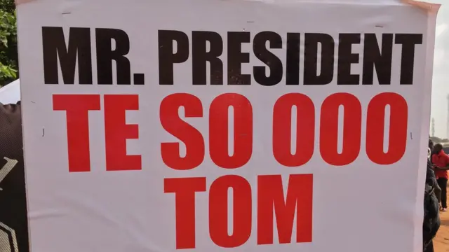 Ghana people carry placard dey protest fuel price