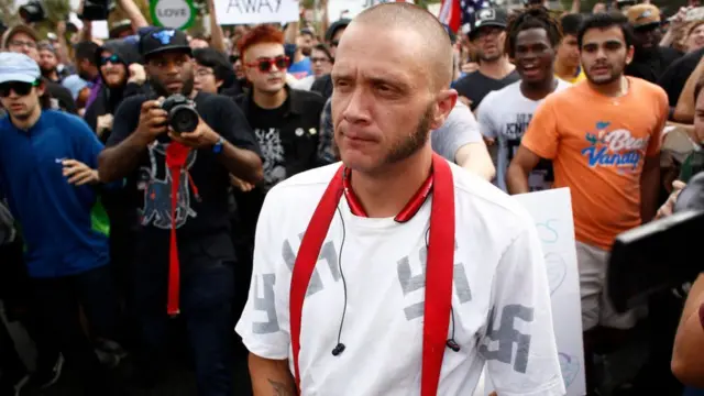 Hombre joven con una camiseta con diseños de la esvástica.