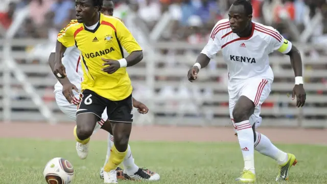 Uganda's Tony Maweye (L) dribbles as he is followed by Kenya's Auxerre midfielder Denis Oliech (R) on October 9, 2010 during their Africa Nations Cup Group J qualifying match in Nairobi. AFP PHOTO /Tony KARUMBA (Photo credit should read TONY KARUMBA/AFP/Getty Images)