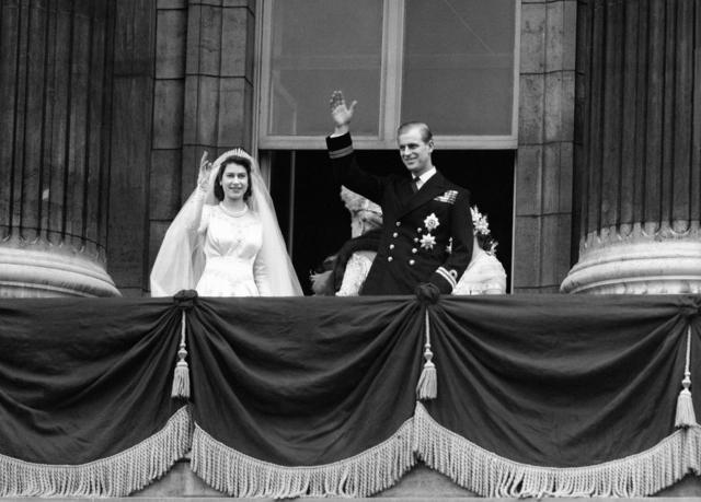La princesa Isabel y el duque de Edimburgo saludando desde el balcón del Palacio de Buckingham después de casarse.