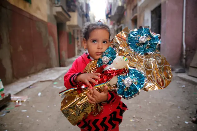 Habiba, 6, hugs Aroset El Moulid or (Bride of Moulid) traditional sugar candy in the shape of dolls, in preparation for the celebration Prophet Muhammad"s birthday, in Tanta, north of Cairo, Egypt November 24, 2017. Picture taken November 24, 2017.