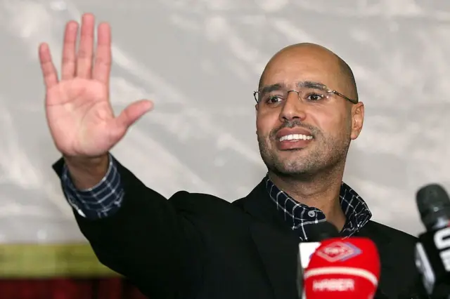 Seif al-Islam Kadhafi, son of Libyan strongman Moamer Kadhafi, waves during a meeting with youths on March 10, 2011 in Tripoli, after he issued a warning of "we're coming" and that his forces were advancing towards their bastion of Benghazi in eastern Libya.
