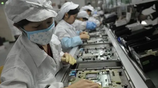 手机的生产线上,成千上万的工人并排而坐
