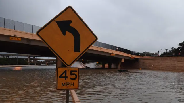 A vehicle lies submerged on the closed I-10 highway after Hurricane Harvey caused heavy flooding in Houston, Texas on August 27, 2017.