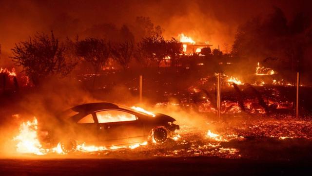 Vehicles and homes burn as the Camp fire tears through Paradise, California