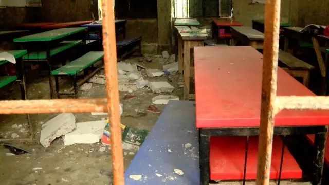 ছড়িয়ে ছিটিয়ে আছে ভাঙা কংক্রিট, বই খাতা। মেঝেতে রক্তের দাগ