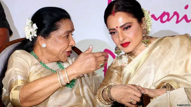 Asha Bhosle (L) and actress Rekha (R) talk during the fifth edition of 'Yash Chopra National Memorial Awards 2018'