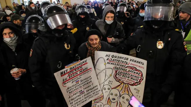 Law enforcement officers escort an elderly woman during an anti-war protest against Russia"s invasion of Ukraine, in Saint Petersburg, Russia