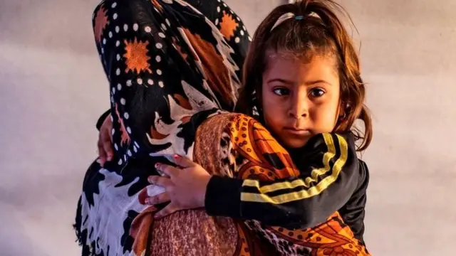 Displaced woman and child in Tuwaynah, north-east Syria (file photo)