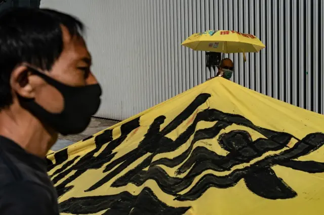 Pro-democracy protesters hold a banner as they march during a rally ahead of Hong Kong Chief Executive Carrie Lams annual policy speech outside of Central Government Complex on October 16, 2019 in Hong Kong, China.