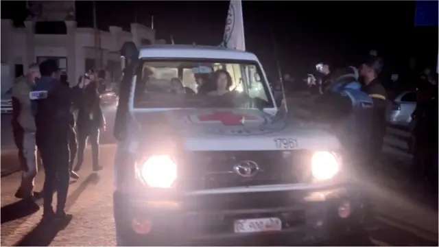 A Red Cross vehicle carries a hostage after their release from Gaza on 29 November 2023