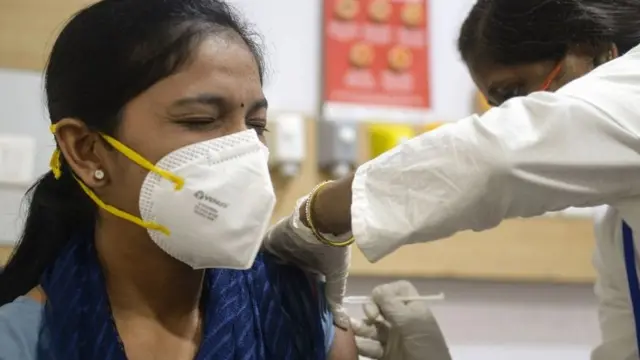 Health worker getting a Covid jab in Hyderabad, India.