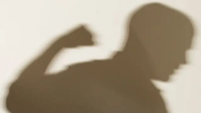 Shadow of man with fist