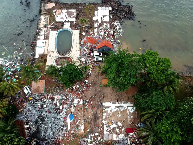An aerial photo shows damaged buildings in Carita on December 23, 2018, after the area was hit by a tsunami on December 22 following an eruption of the Anak Krakatoa volcano.
