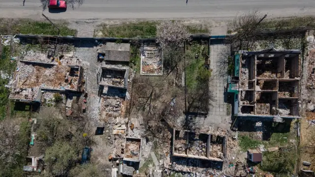 In this aerial view, destroyed houses are seen on 28 April 2022 in Zahaltsi, Ukraine