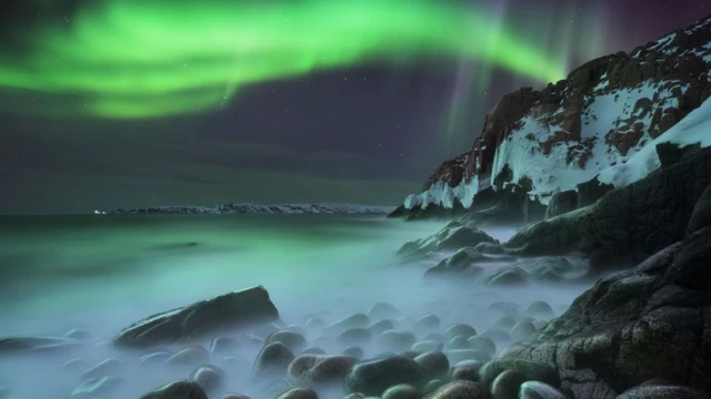 Northern Lights on a stone beach in Russia.