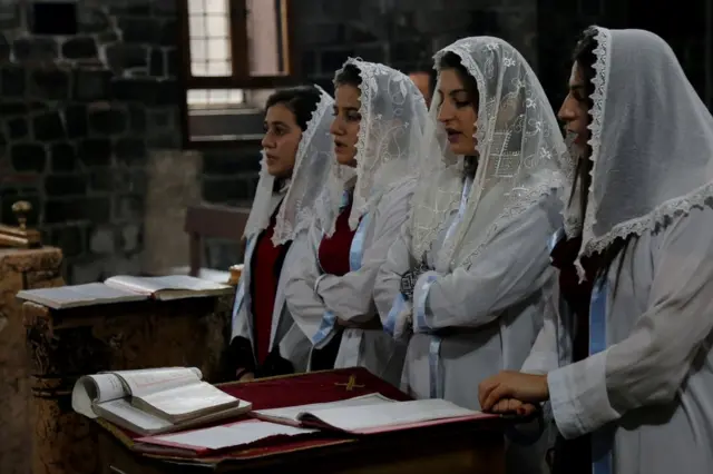 Syriac Christian girls, who are members of the choir, attend a mass on Christmas at the Virgin Mary Syriac Orthodox Church in Diyarbakir, Turkey, December 25, 2017