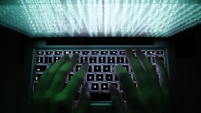 Man types of computer keyboard