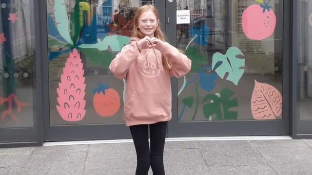 Freya standing outside the door to Great Ormond Street Hospital