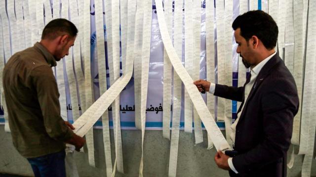 موظفون في مفوضية الانتخابات يفرزون أصوات التصويت الخاص في مدينة النجف