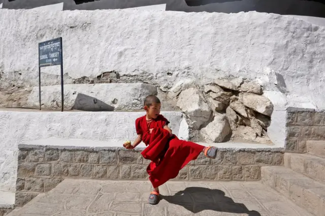 A young monk plays during a break from his studies inside Thiksey Monastery in Ladakh, India.