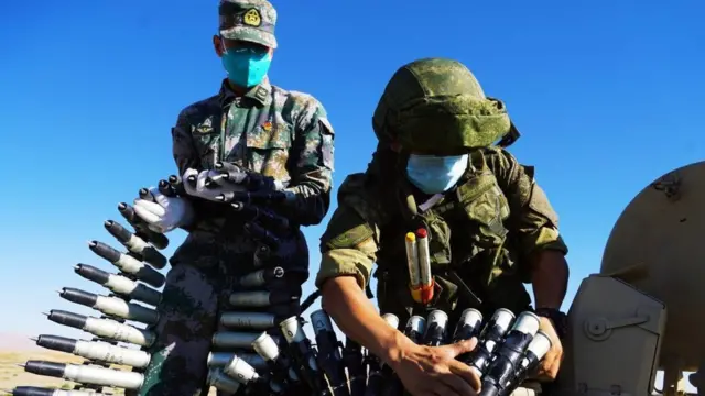 Chinese Soldier training Russian soldier using Chinese tanks