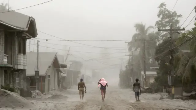 Residents living near the errupting Taal Volcano evacuate in Agoncillo, Batangas City