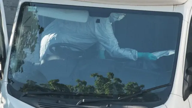 Forensic teams examine the hire van