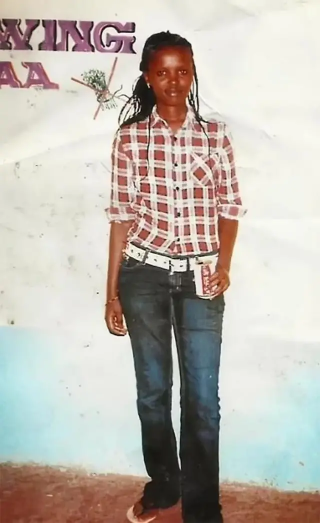 A full-body photo of Agnes Wanjiru wearing jeans and a chequered shirt