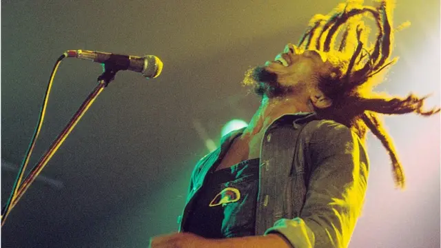 Bob Marley cantando y sus cabellos vuelan