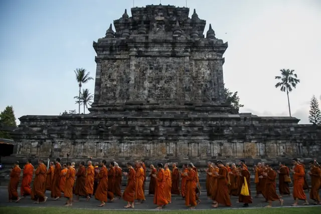 Buddhist monks walk around Mendut temple during the practice of Pradakshina ahead of Vesak Day in Magelang, Central Java, Indonesia, May 27, 2018