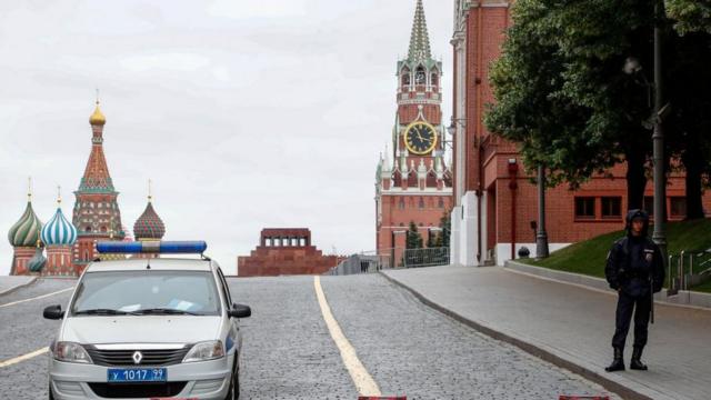 Russian policemen stand guard in front of the Kremlin near Red Square